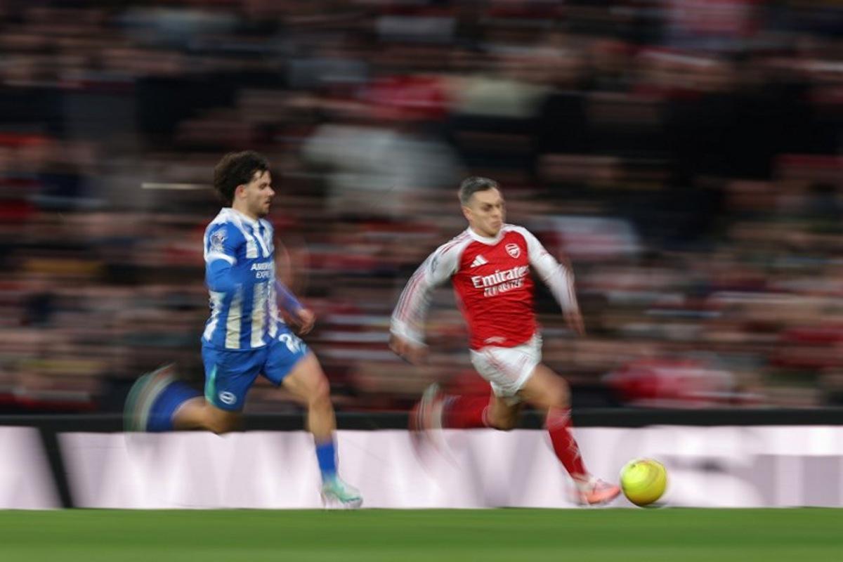 Arsenal's Belgian midfielder #19 Leandro Trossard (R) is chased by Brighton's Turkish defender #24 Ferdi Kadioglu (L) during the English Premier League football match between Arsenal and Brighton and Hove Albion at the Emirates Stadium in London on December 27, 2025. Adrian Dennis / AFP