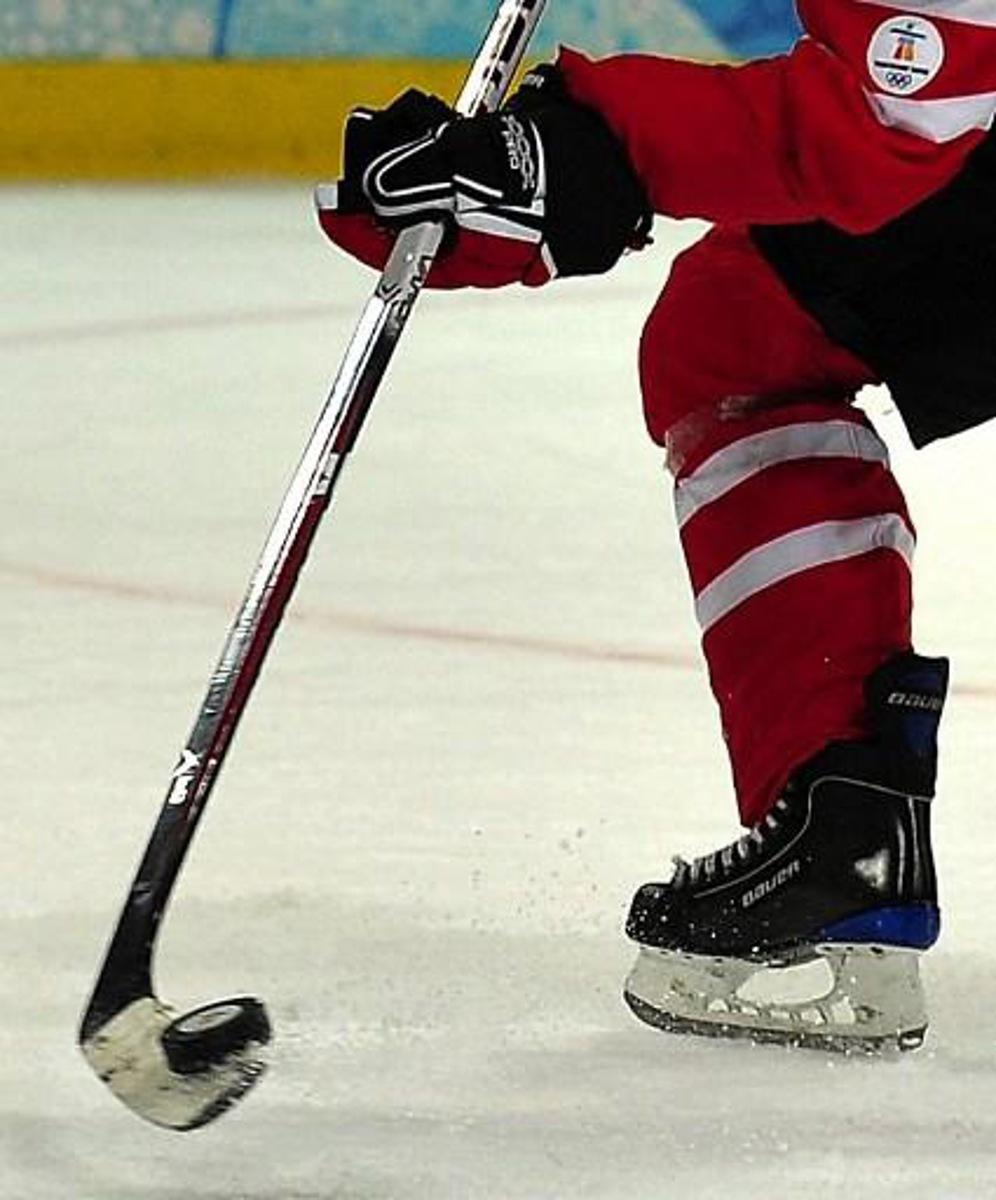 A Canadian player stick handles the puck during the Women's Ice Hockey preliminary game between Switzerland and Canada at the UBC Thunderbird Arena during the XXI Winter Olympic Games in Vancouver, Canada on February 15, 2010. AFP PHOTO/Luis ACOSTA