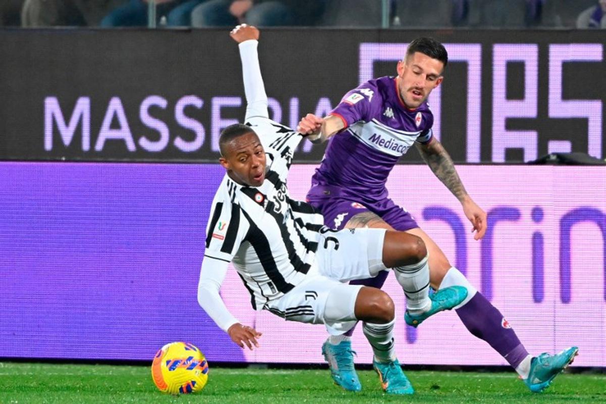 Juventus' midfielder Franch Marley Ake (L) is challenged by Fiorentina's Italian defender Cristiano Biraghi during the Italian Cup (Coppa Italia) semi-final first leg football match Fiorentina vs Juventus at the Artemio-Franchi stadium in Florence on March 2, 2022. Alberto PIZZOLI / AFP