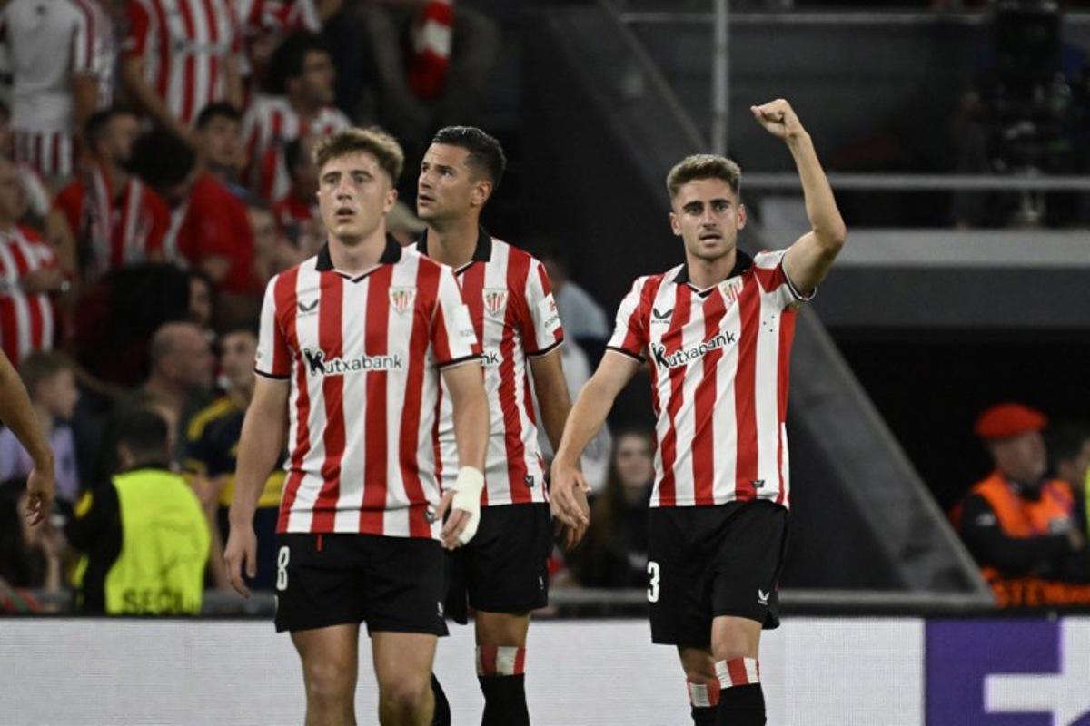 Athletic Bilbao's Spanish forward #23 Robert Navarro (R) celebrates scoring his team's second goal during the UEFA Champions League league phase day 3 football match between Athletic Club Bilbao and Qarabagh at San Mames Stadium in Bilbao on October 22, 2025. ANDER GILLENEA / AFP