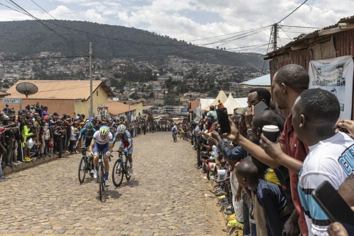 Residents gather to look at cyclists competing during the final stage of the 16h Tour du Rwanda on 25 february 2024, in Kigali. Israel Premier Tech's British rider Joseph Blackmore, won the Tour of Rwanda which ended on Sunday in the capital Kigali. Guillem Sartorio / AFP