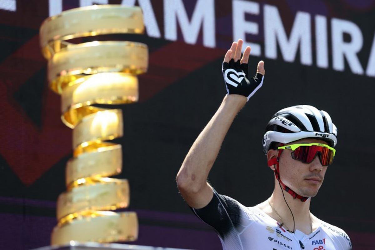 UAE Team Emirates XRG's Spanish rider Juan Ayuso waves before the start of the 18th stage of the 108th Giro d'Italia cycling race of 144kms from Morbegno to Cesano Maderno on May 29, 2025. Luca Bettini / AFP
