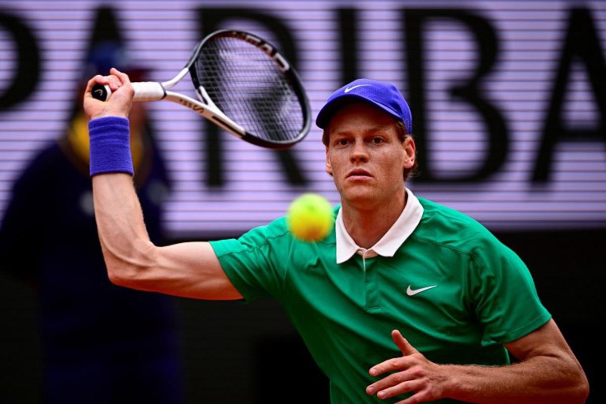 Italy's Jannik Sinner plays a forehand return to Kazakhstan's Alexander Bublik during their quarter-final men's singles match on day 11 of the French Open tennis tournament on Court Philippe-Chatrier at the Roland-Garros Complex in Paris on June 4, 2025. JULIEN DE ROSA / AFP