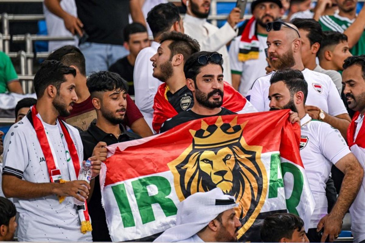 An Iraq supporter cheers for his team with a stylised national flag before the 2026 FIFA World Cup Asian qualification football match between Kuwait and Iraq at Jaber al-Ahmad International Stadium in Kuwait City on September 10, 2024. YASSER AL-ZAYYAT / AFP