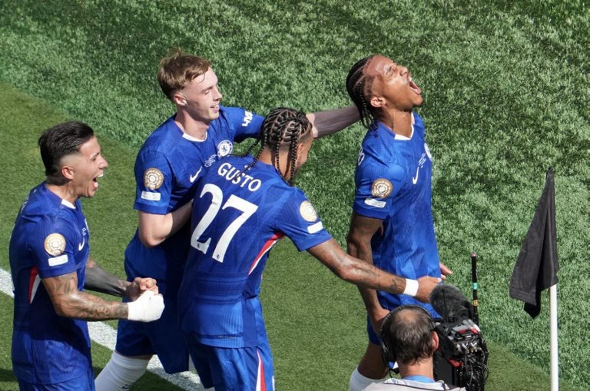 Chelsea's Brazilian forward #20 Joao Pedro (R) celebrates scoring his team's third goal during the FIFA Club World Cup 2025 final football match between England's Chelsea and France's Paris Saint-Germain at the MetLife Stadium in East Rutherford, New Jersey on July 13, 2025. TIMOTHY A. CLARY / AFP