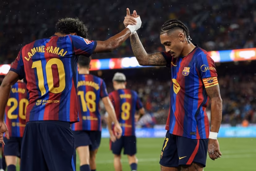 Barcelona's Brazilian forward #11 Raphinha celebrates scoring his team's second goal from the penalty spot with Barcelona's Spanish forward #10 Lamine Yamal during the Spanish league football match between FC Barcelona and Racing Santander at the Camp Nou stadium in Barcelona on September 16, 2026. Lluis GENE / AFP