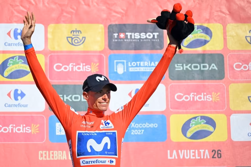 Overall leader Team Movistar's Spanish rider Enric Mas celebrates on the podium retaining the red jersey after the 20th stage of the Vuelta a Espana 2026 cycling tour, a 186,8 km race between La Calahorra and Collado del Alguacil, on September 12, 2026. Home favourite Enric Mas moved to the brink of Vuelta a Espana victory today as he finished the 20th and penultimate stage by extending his lead on Primoz Roglic in the overall standings. JORGE GUERRERO / AFP