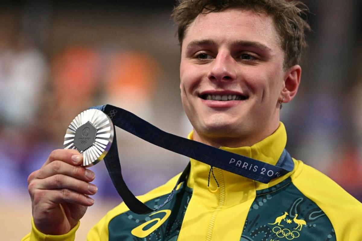 Silver medallist Australia's Matthew Richardson poses on the podium of the men's track cycling sprint event of the Paris 2024 Olympic Games at the Saint-Quentin-en-Yvelines National Velodrome in Montigny-le-Bretonneux, south-west of Paris, on August 9, 2024. SEBASTIEN BOZON / AFP