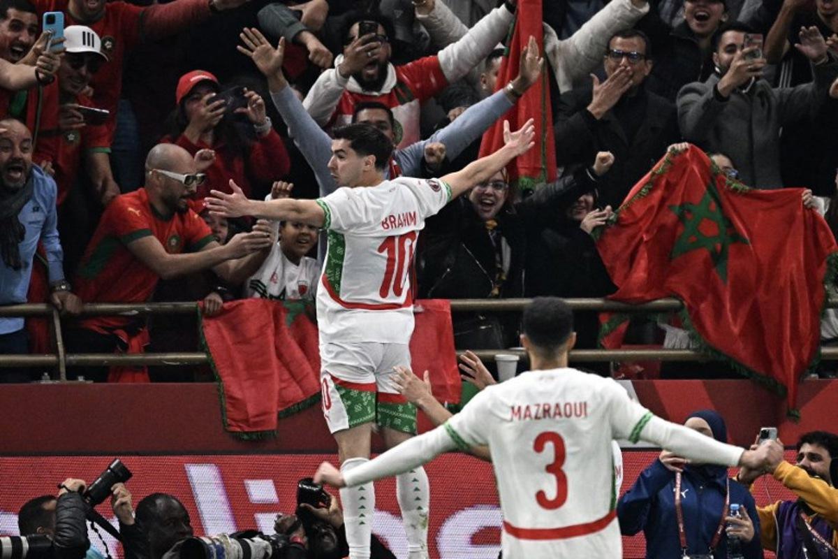 Morocco's forward #10 Brahim Diaz (L) celebrates scoring his team's first goal during the Africa Cup of Nations (CAN) quarter-final football match between Cameroon and Morocco at the Prince Moulay Abdallah stadium in Rabat on January 9, 2026. Gabriel BOUYS / AFP