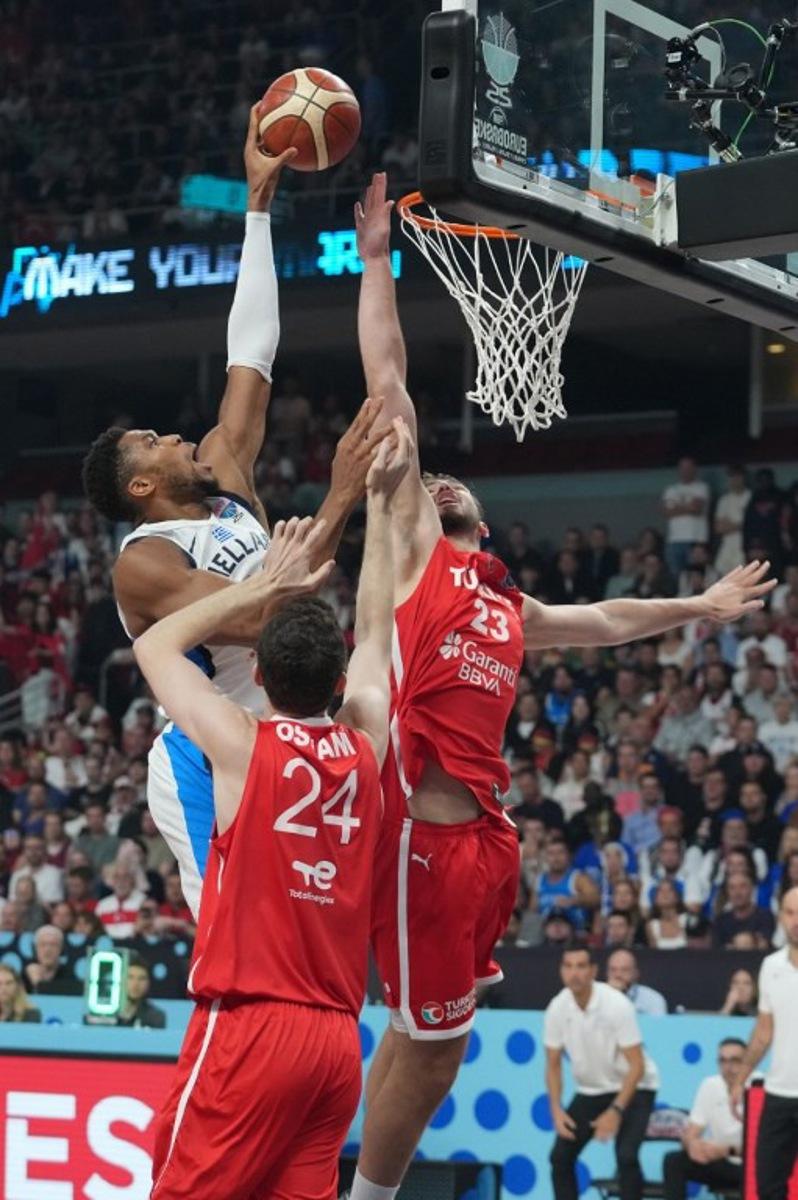 Greece's small forward #34 Giannis Antetokounmpo (L), Turkey's center #24 Ercan Osmani (C) and Turkey's power forward #23 Alperen Sengun vie for the ball during the FIBA EuroBasket 2025 semi-final basketball match between Greece and Turkey in Riga, Latvia, on September 12, 2025. Gints Ivuskans / AFP