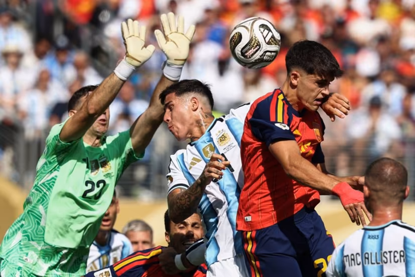 Argentina's midfielder #24 Enzo Fernandez and Spain's defender #22 Pau Cubarsi fight for the ball past Argentina's goalkeeper #23 Emiliano Martinez during the 2026 World Cup football tournament final match between Spain and Argentina at the New York/New Jersey Stadium in East Rutherford on July 19, 2026. FRANCK FIFE / AFP