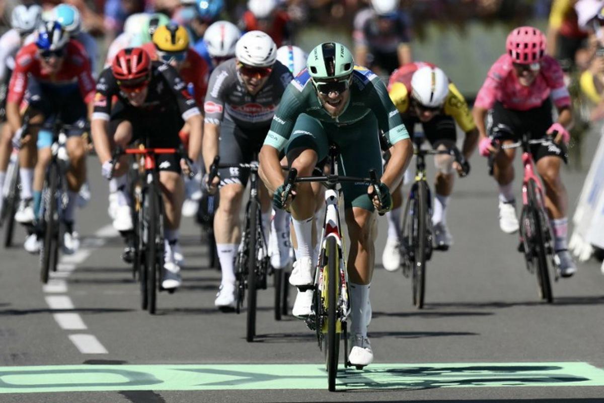 Lidl - Trek team's Italian rider Jonathan Milan wearing the best sprinter's green jersey sprints to the finish line ahead of Team Visma - Lease a bike team's Belgian rider Wout van Aert placing second and Alpecin - Deceuninck team's Australian rider Kaden Groves placing third during the 8th stage of the 112th edition of the Tour de France cycling race, 171.4 km between Saint-Meen-le-Grand and Laval Espace Mayenne, western France, on July 12, 2025. Marco BERTORELLO / AFP
