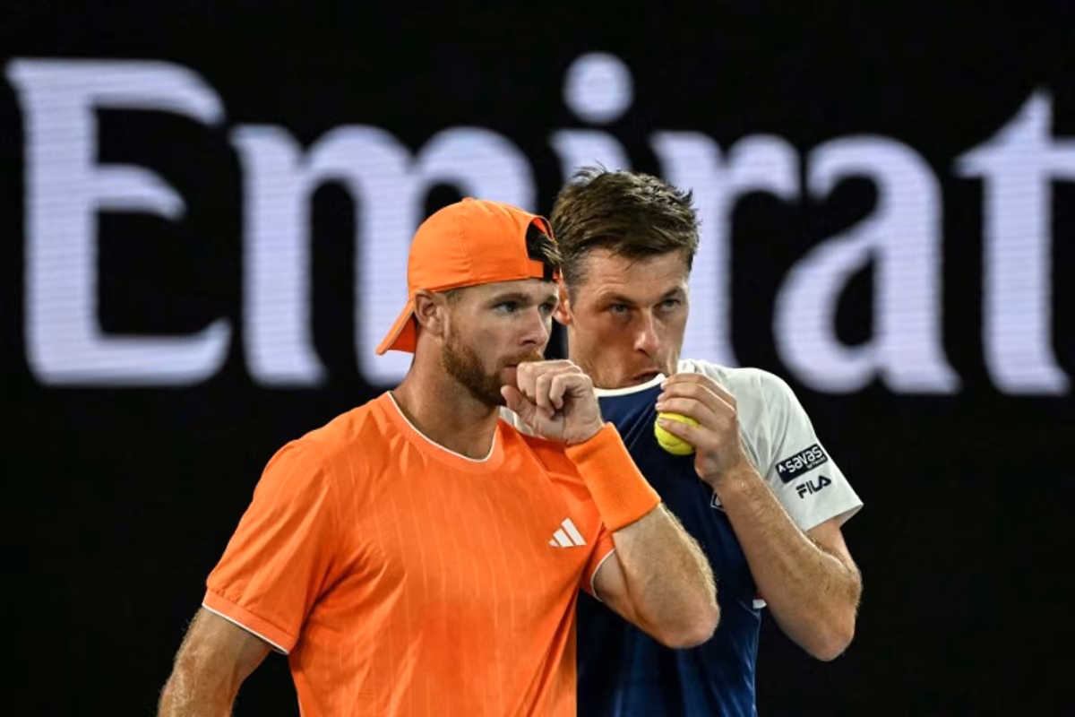 Great Britain's Neal Skupski (R) speaks with partner USA's Christian Harrison during their men's doubles final match against Australia's Jason Kubler and Marc Polmans on day fourteen of the Australian Open tennis tournament in Melbourne on January 31, 2026. WILLIAM WEST / AFP