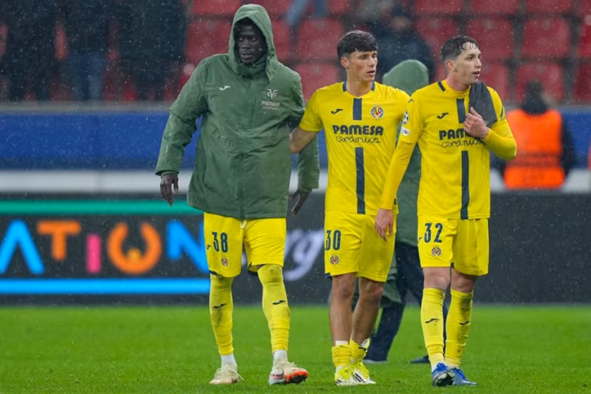 Villarreal's Senegalese midfielder #38 Alassane Diatta, Villarreal's Spanish defender #30 Daniel Budesca and Villarreal's Spanish midfielder #32 Hugo Lopez react at the end of the UEFA Champions League league phase - Day 8 football match between Bayer Leverkusen and Villarreal CF at the BayArena stadium in Leverkusen, western Germany on January 28, 2026. Pau Barrena / AFP