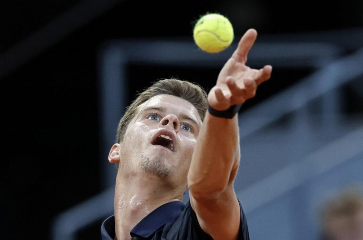 Belgium's Alexander Blockx tosses the ball into the air prior to serving against Germany's Alexander Zverev during their 2026 ATP Tour Madrid Open tennis tournament semi-final singles match at the Caja Magica in Madrid, on May 1, 2026. OSCAR DEL POZO / AFP