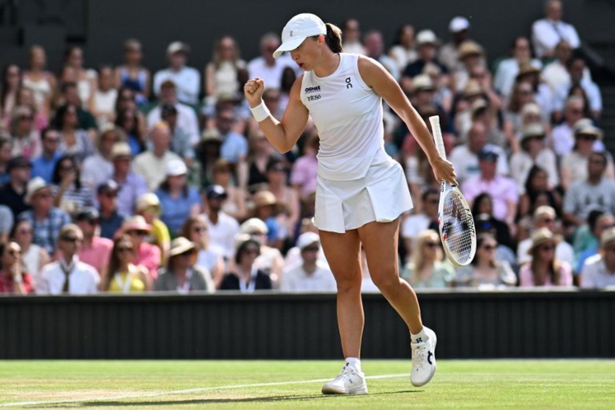 Poland's Iga Swiatek celebrates winning a point against US player Amanda Anisimova during their women's singles final tennis match on the thirteenth day of the 2025 Wimbledon Championships at The All England Lawn Tennis and Croquet Club in Wimbledon, southwest London, on July 12, 2025. Kirill KUDRYAVTSEV / AFP