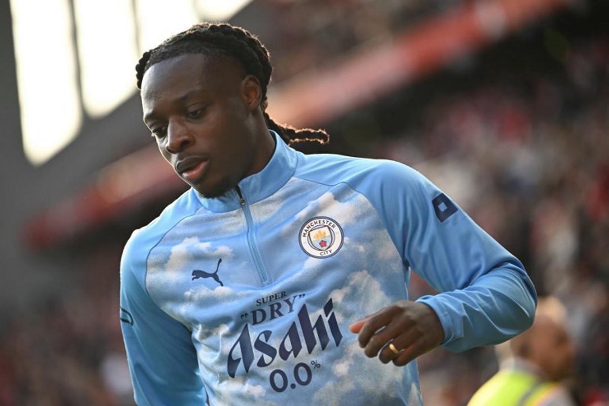 Manchester City's Belgian midfielder #11 Jeremy Doku warms up ahead of the English Premier League football match between Liverpool and Manchester City at Anfield in Liverpool, north west England on October 11, 2026. Paul ELLIS / AFP