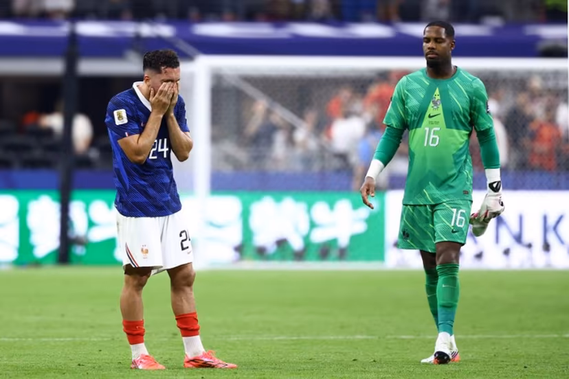 France's forward #24 Rayan Cherki and goalkeeper #16 Mike Maignan react after losing the 2026 World Cup football tournament semi-final match between France and Spain at the Dallas Stadium in Arlington on July 14, 2026. CHARLY TRIBALLEAU / AFP