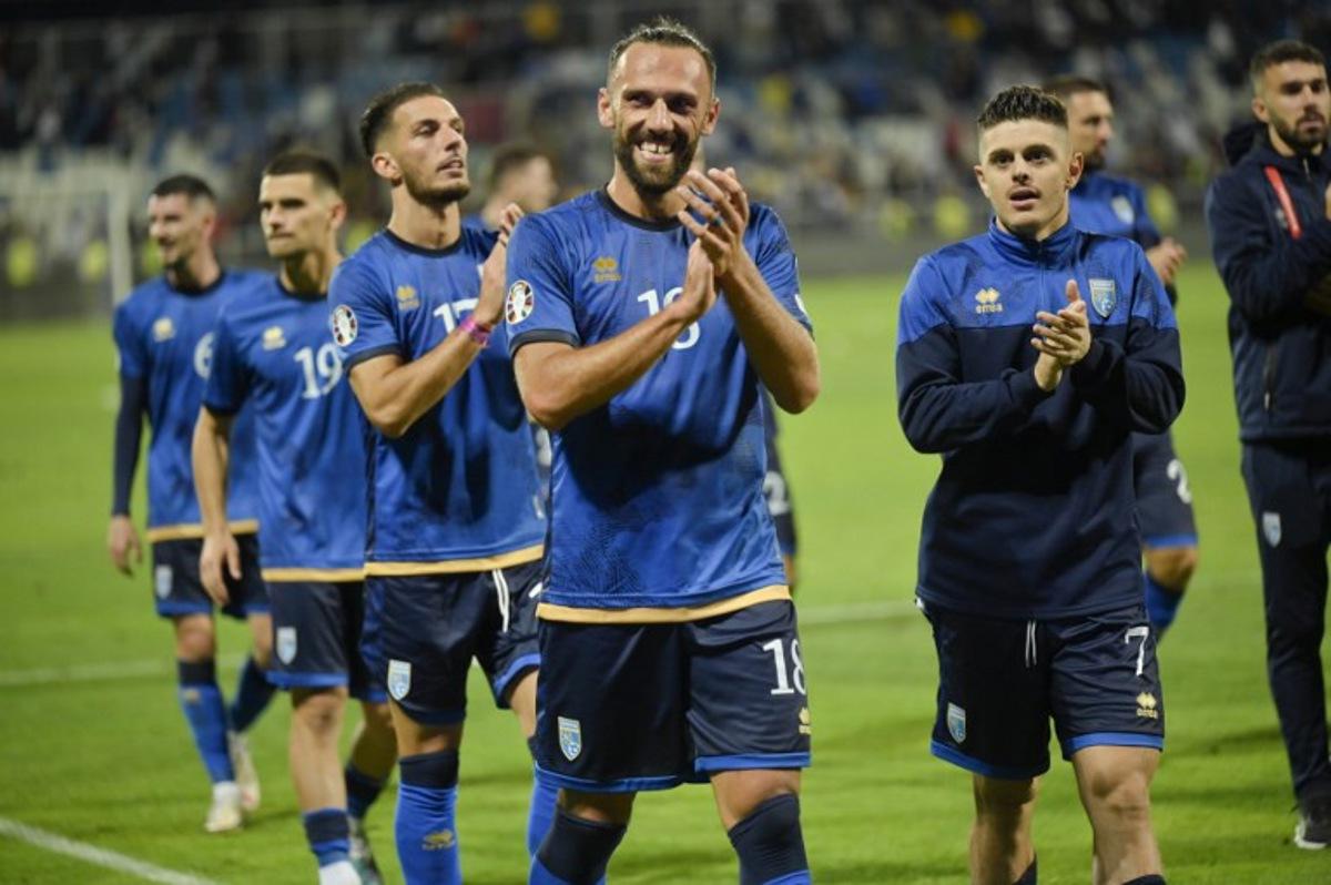 Kosovo's striker #18 Vedat Muriqi celebrates with teammates after scoring his team's second goal during the UEFA Euro 2024 Group I qualification football match between Kosovo and Switzerland, at the "Fadil vokrri" Stadium in Pristina on September 9, 2023. Armend NIMANI / AFP