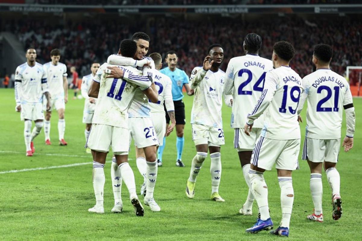 Aston Villa's English striker #11 Ollie Watkins (front L) celebrates with teammates after scoring his team's first goal during the UEFA Europa League round of 16 first leg football match between Lille (LOSC) and Aston Villa at the Pierre-Mauroy Stadium in Villeneuve-d'Ascq, northern France, on March 12, 2026. Sameer AL-DOUMY / AFP