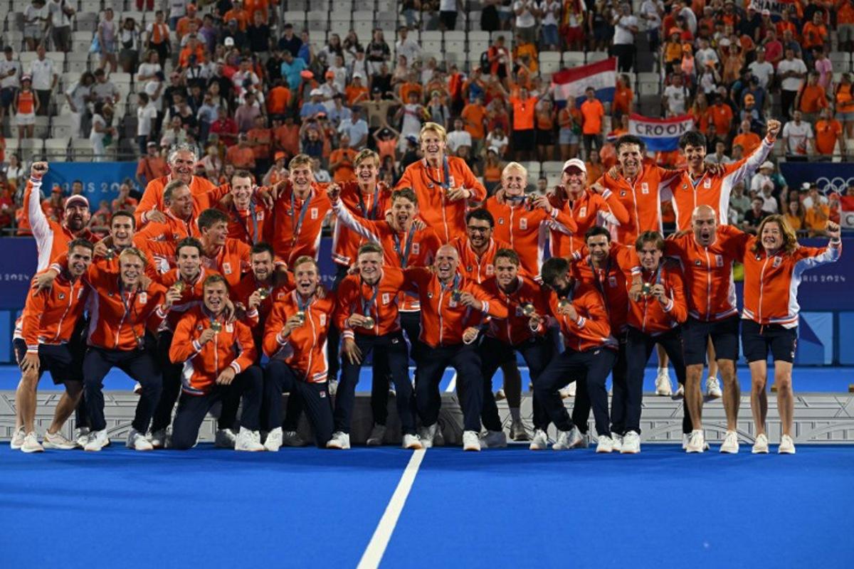 Netherlands' players pose on the podium with their gold medals after the men's final field hockey match between Germany and the Netherlands during the Paris 2024 Olympic Games at the Yves-du-Manoir Stadium in Colombes on August 8, 2024. Arun SANKAR / AFP