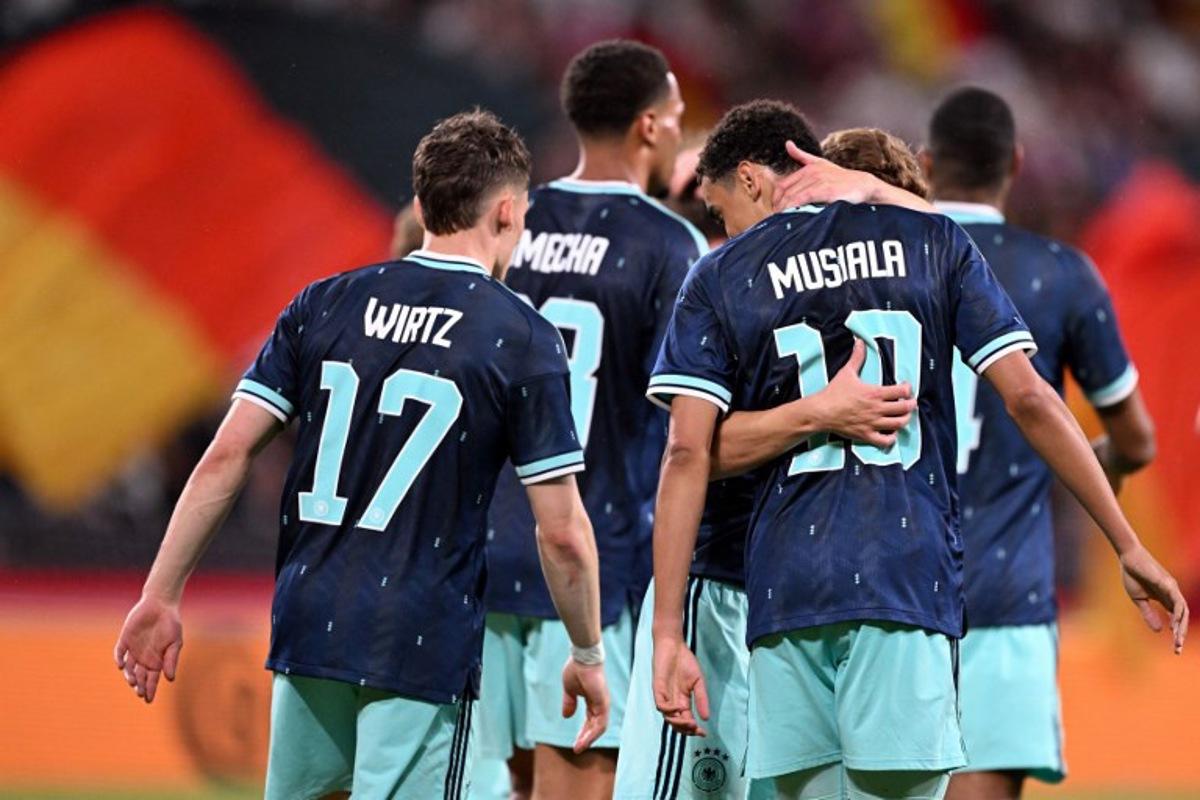 Germany's midfielder #10 Jamal Musiala (R) celebrates scoring his team's fourth goal with teammate Germany's midfielder #17 Florian Wirtz and others during a friendly match between Germany and Finland ahead of the 2026 FIFA World Cup football tournament, in Mainz, western Germany on May 31, 2026. Kirill KUDRYAVTSEV / AFP