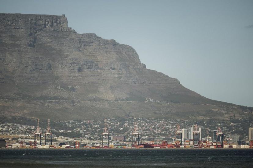 A general view of Table Mountain and the Cape Town City bowl is seen on December 18, 2025. Nestled between spectacular mountains and the Atlantic Ocean, Cape Town has emerged as a growing tourism destination, topping in 2025 the Telegraph and Time Out magazine's rankings of best cities in the world. Activists say the drive to profit from tourism accommodation is pricing locals out of coveted neighbourhoods, including areas near District Six -- a site long associated with the apartheid-era removals that displaced non-white communities to remote, underdeveloped townships. GIANLUIGI GUERCIA / AFP