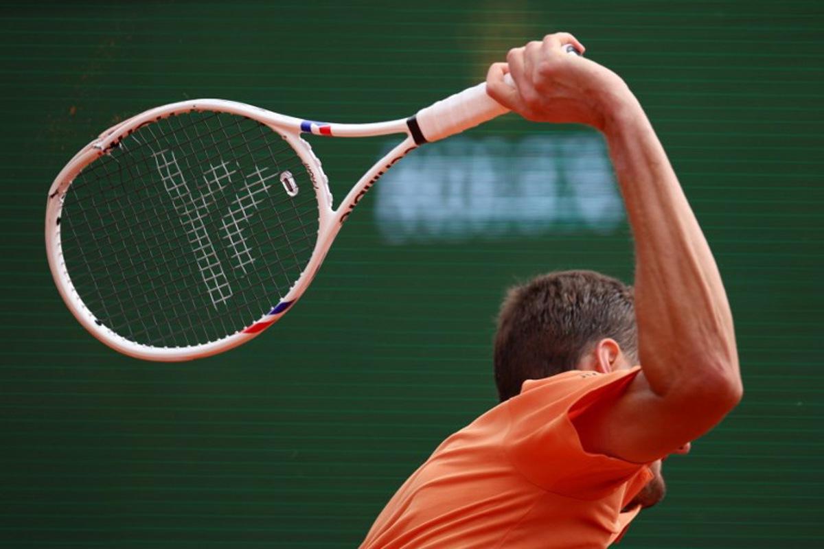 Russia's Daniil Medvedev smashes his racket on the clay as he plays against Italy's Matteo Berrettini during the Monte Carlo ATP Masters Series Tournament round of 32 tennis match on Court Rainier III at the Monte-Carlo Country Club in Roquebrune-Cap-Martin, south-eastern France on April 8, 2026. Valery HACHE / AFP