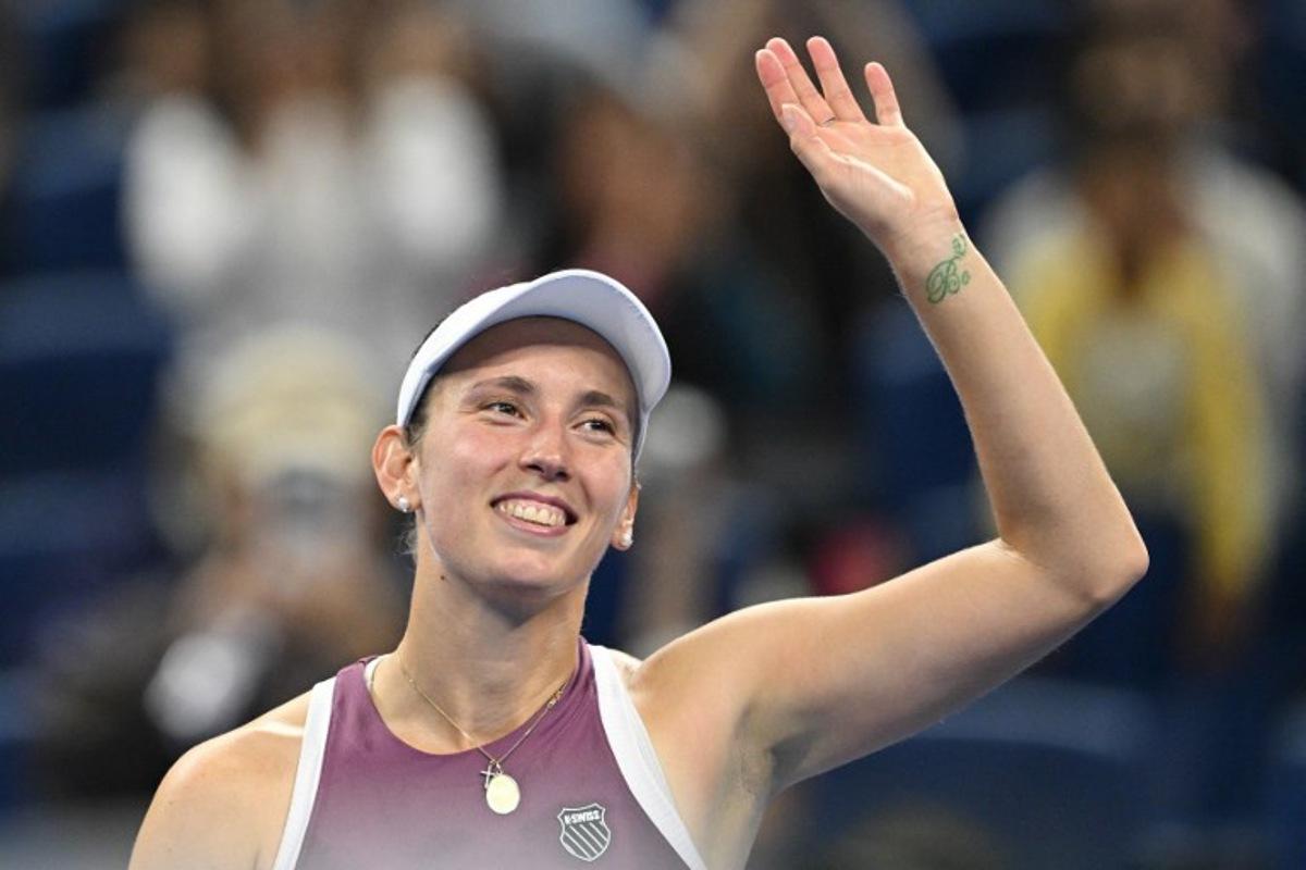 Belgium's Elise Mertens celebrates after beating Poland's Iga Swiatek in their women's singles quarter-final at the China Open tennis tournament in Beijing on October 9, 2026. GREG BAKER / AFP