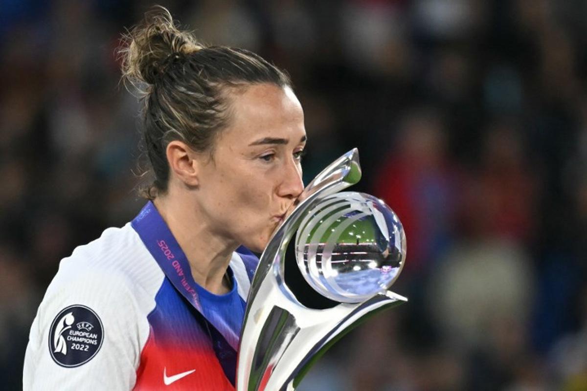 England's defender #02 Lucy Bronze kisses the trophy as they celebrate winning the UEFA Women's Euro 2025 final football match between England and Spain at the St. Jakob-Park Stadium in Basel, on July 27, 2025. England beat Spain 3-1 on penalties to win the Women's Euro 2025. Fabrice COFFRINI / AFP