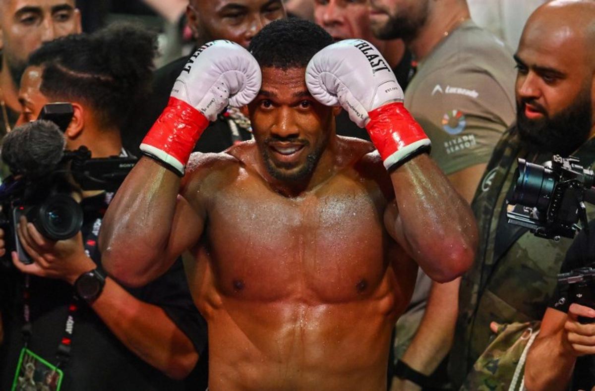 British boxer Anthony Joshua celebrates after defeating US boxer and influencer Jake Paul (off frame) in a non-title heavyweight bout at the Kaseya Center in Miami, Florida, on December 19, 2025. Giorgio VIERA / AFP