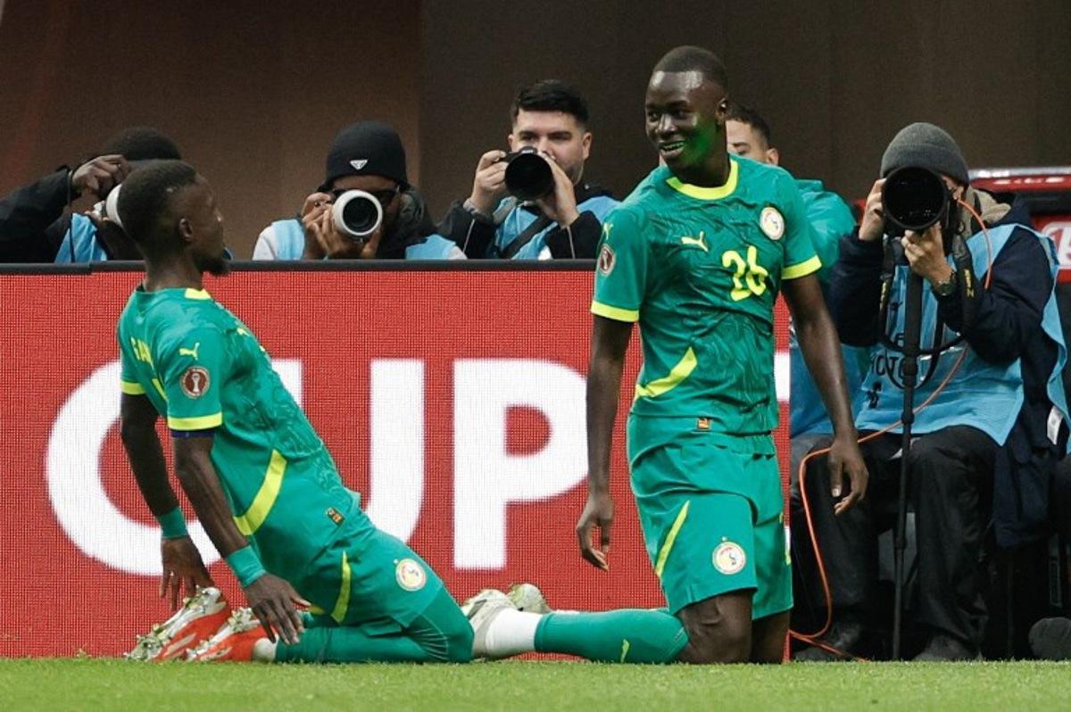 Senegal's midfielder #26 Pape Gueye (R) celebrates scoring his team's second goal during the Africa Cup of Nations (CAN) round of 16 football match between Senegal and Sudan at Grand Stadium in Tangiers on January 3, 2026. Abdel Majid BZIOUAT / AFP