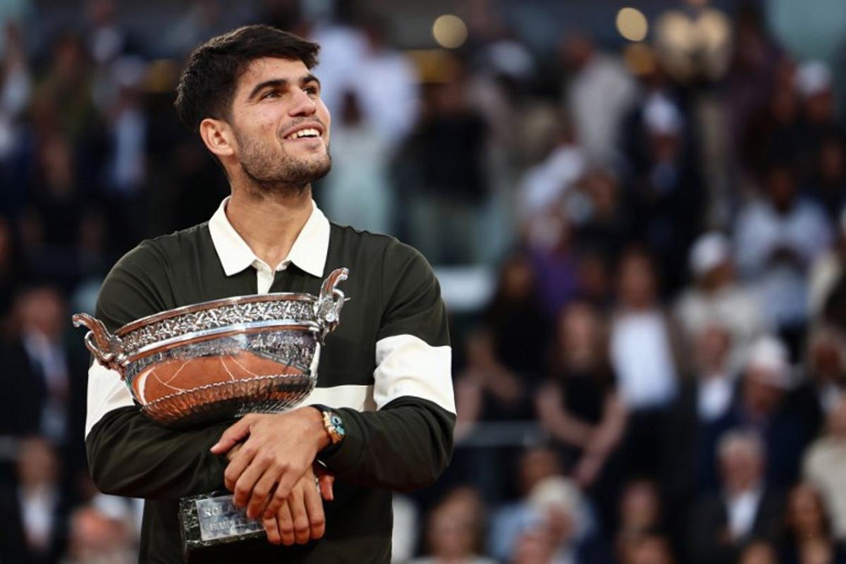 Spain's Carlos Alcaraz holds the trophy after winning the men's singles final match against Italy's Jannik Sinner on day 15 of the French Open tennis tournament on Court Philippe-Chatrier at the Roland-Garros Complex in Paris on June 8, 2025. Thibaud MORITZ / AFP