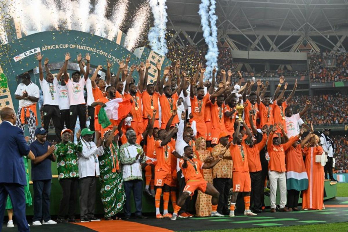 Ivory Coast's forward #15 Max-Alain Gradel lifts the Africa Cup of Nations trophy on the podium after Ivory Coast won the Africa Cup of Nations (CAN) 2024 final football match between Ivory Coast and Nigeria at Alassane Ouattara Olympic Stadium in Ebimpe, Abidjan on February 11, 2024. Issouf SANOGO / AFP