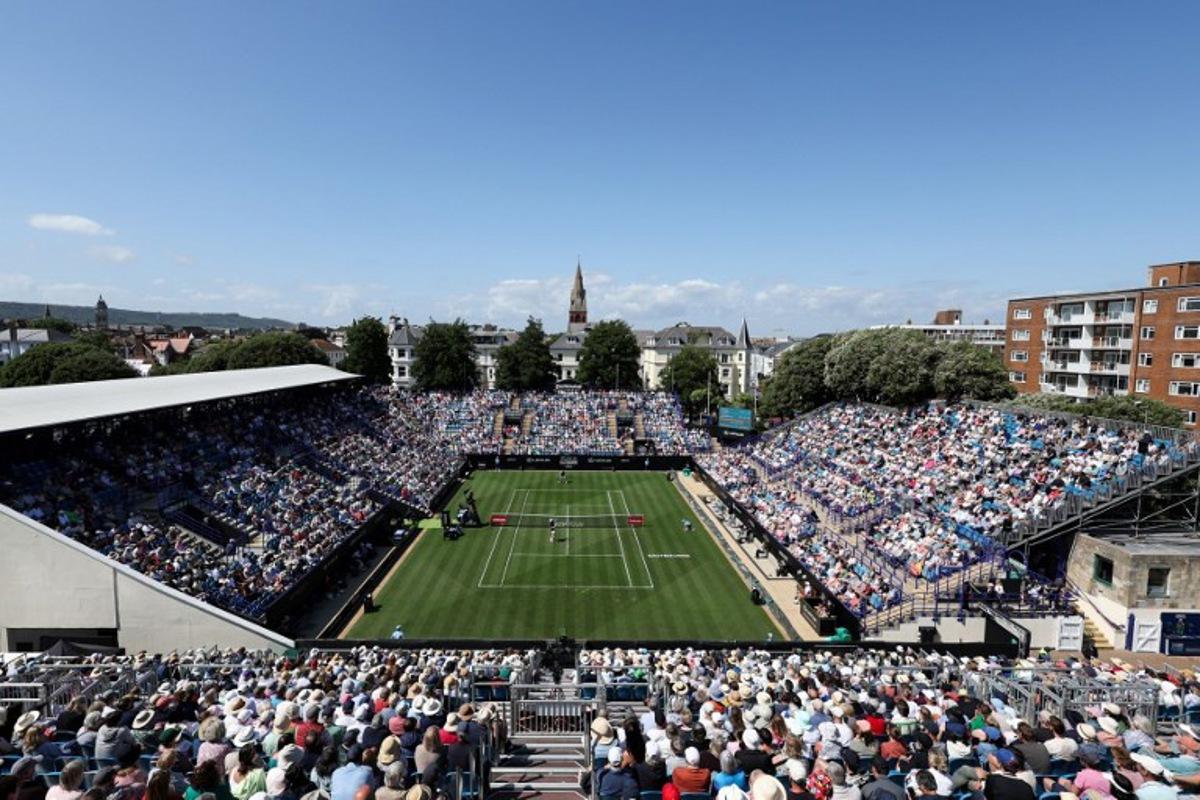 Serbia's Miomir Kecmanovic (down) plays a return to Britain's Daniel Evans during their men's singles tennis match on day one at the Rothesay Eastbourne International tennis tournament in Eastbourne, southern England, on June 23, 2025. Adrian Dennis / AFP