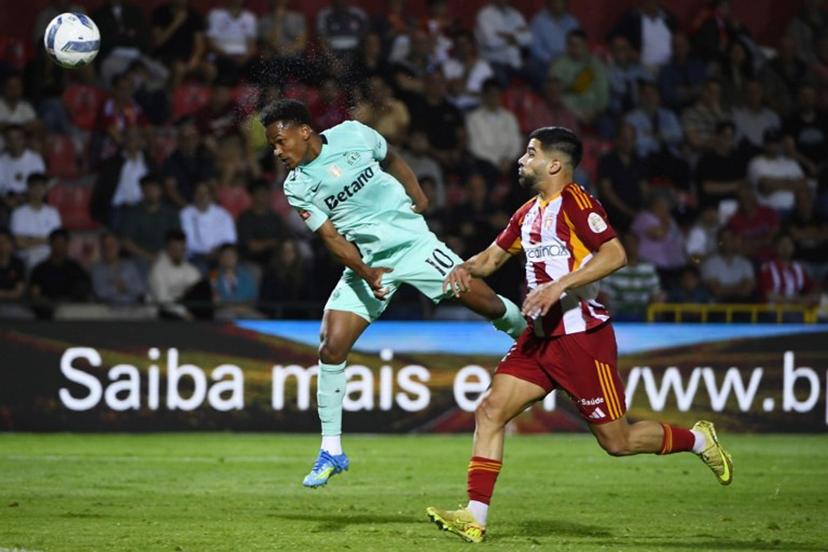 Sporting Lisbon's Mozambican forward #10 Geny Catamo heads the ball next to AVS' Nigerian forward #11 Tunde Akinsola during the Portuguese League football match between AVS Futebol SAD and Sporting CP at CD Aves stadium in Vila das Aves on April 26, 2026. MIGUEL LEMOS / AFP
