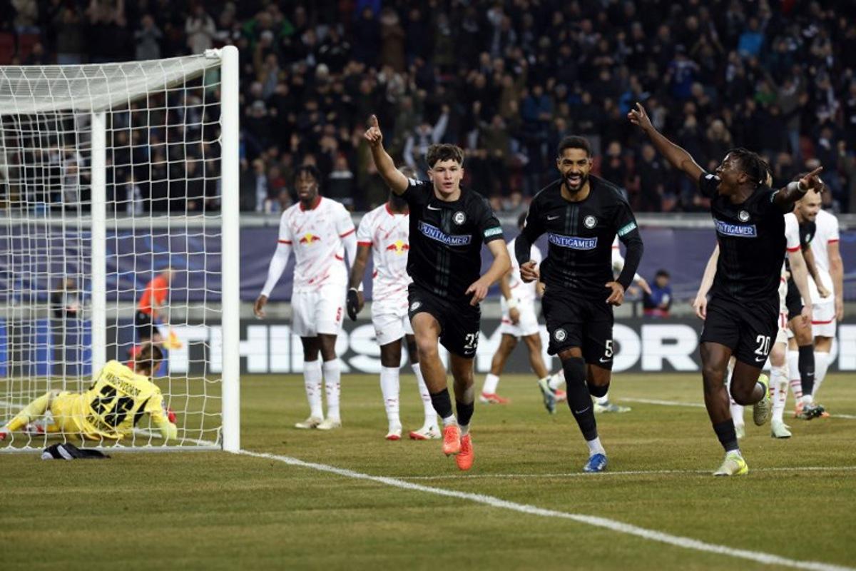 Sturm Graz's Slovenian defender #23 Arjan Malic (2L) celebrates with teammates Sturm Graz's Swiss defender #05 Gregory Wuethrich (2R) and Sturm Graz's Norwegian forward #20 Seedy Jatta after he scored his team's first goal past Leipzig's Belgian goalkeeper #26 Maarten Vandevoordt during the UEFA Champions League football match between SK Sturm Graz and RB Leipzig in Klagenfurt, Austria on January 29, 2025. ERWIN SCHERIAU / APA / AFP