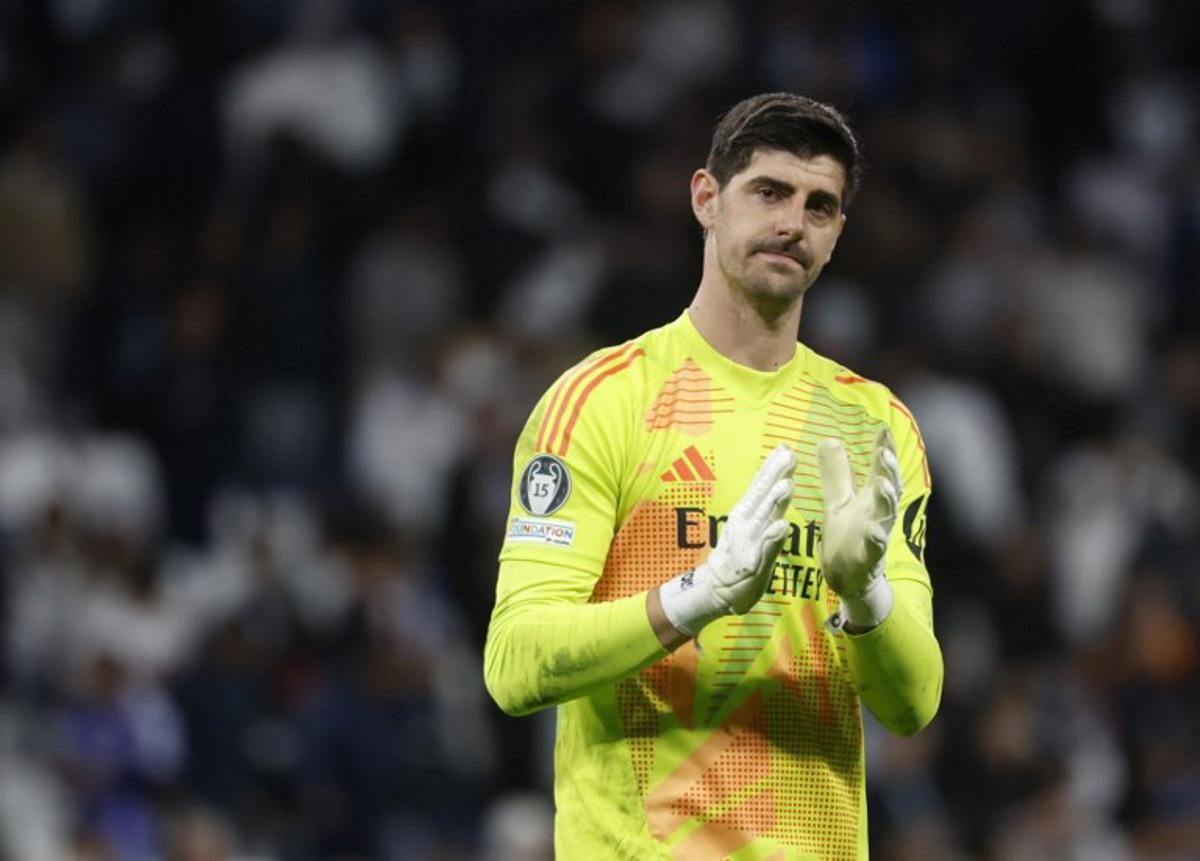 Real Madrid's Belgian goalkeeper #01 Thibaut Courtois applauds at the end of the UEFA Champions League quarter final second leg football match between Real Madrid CF and Arsenal at Santiago Bernabeu Stadium in Madrid on April 16, 2025. Pierre-Philippe MARCOU / AFP