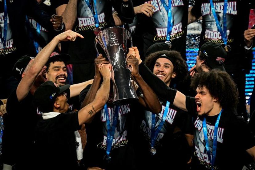 Paris' team celebrates with the trophy on the podium after winning the Eurocup second leg basketball match between JL Bourg (Bourg-en-Bresse) and Paris basketball at the Ekinox arena in Bourg-en-Bresse, central eastern, on April 12, 2024. OLIVIER CHASSIGNOLE / AFP