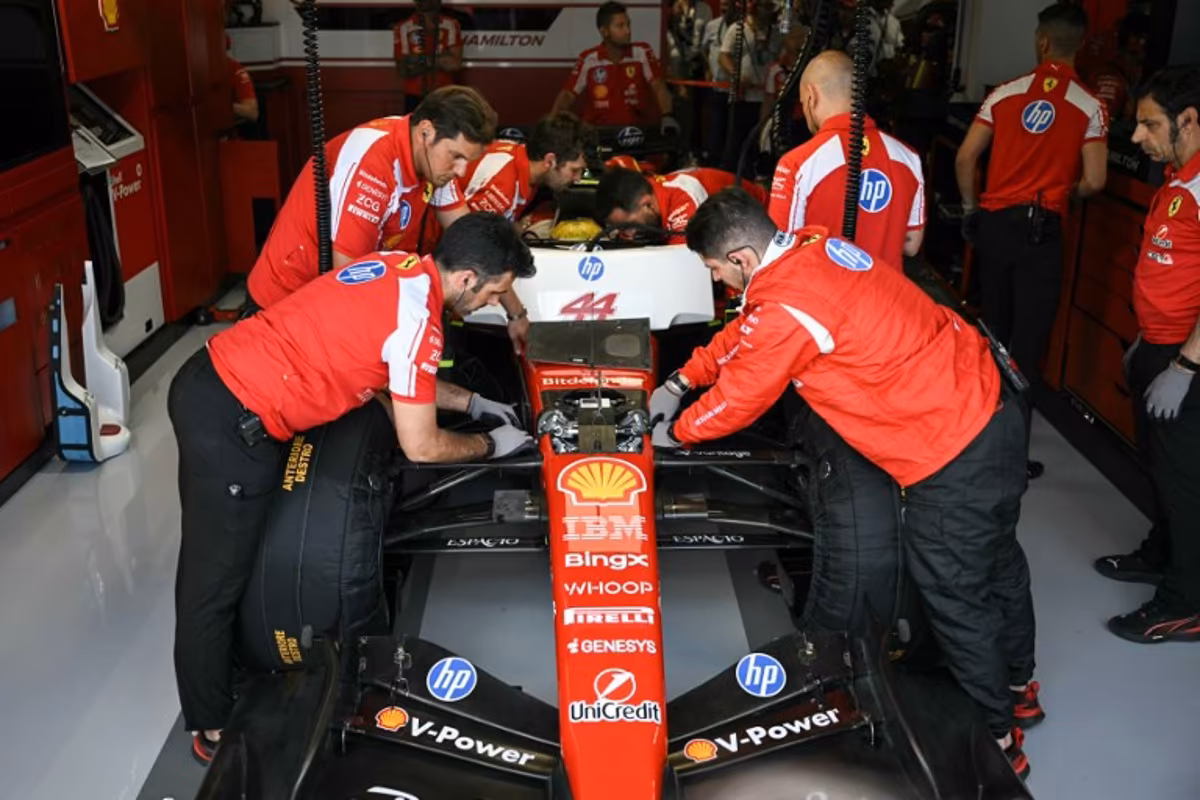 Ferrari technicians work on the car of Ferrari's British driver Lewis Hamilton in the garage during a practice session for the 2026 Miami Formula One Grand Prix at Miami International Autodrome in Miami Gardens, Florida, on May 1, 2026. CHANDAN KHANNA / AFP