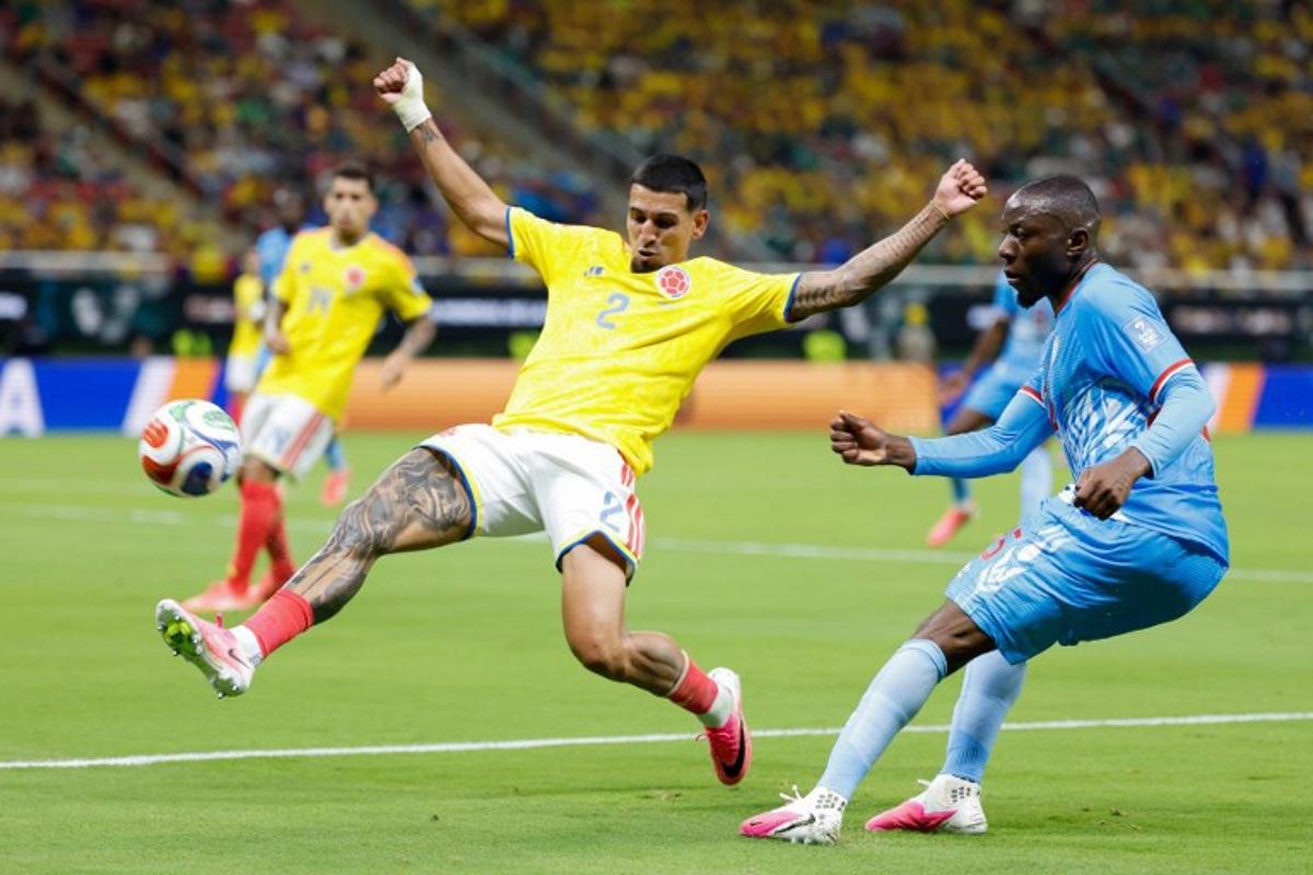 Colombia's defender #02 Daniel Munoz and Congo DR's midfielder #25 Edo Kayembe fight for the ball during the 2026 World Cup Group K football match between Colombia and Democratic Republic of Congo at the Guadalajara Stadium in Zapopan on June 23, 2026. Ulises RUIZ / AFP
