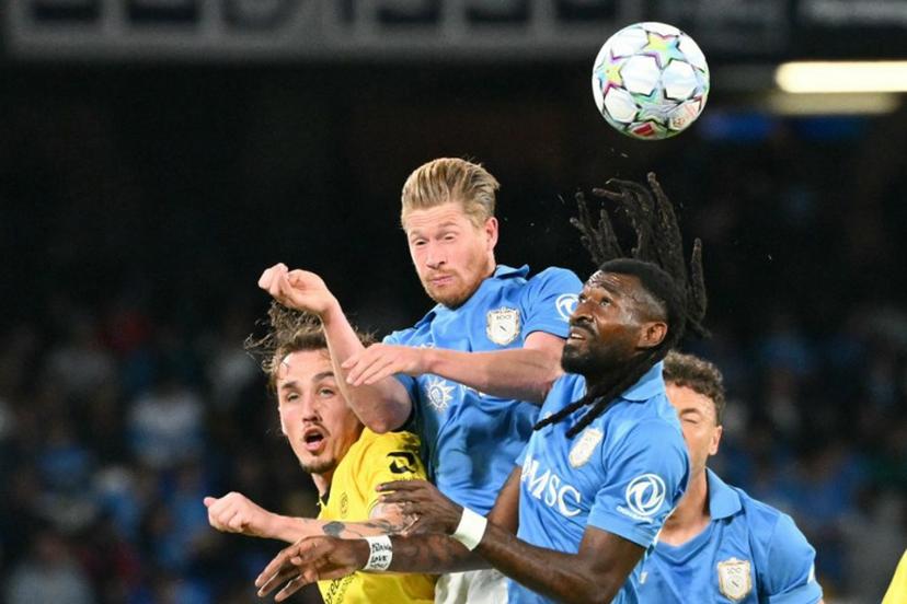 Napoli's Cameroonian midfielder #99 Andre-Frank Anguissa and Napoli's Belgian midfielder #11 Kevin De Bruyne jump for the ball during the UEFA Champions League - first round day 3 football match between Napoli and Bodo Glimt at the Diego Armando Maradona stadium in Naples on October 20, 2026. Alberto PIZZOLI / AFP