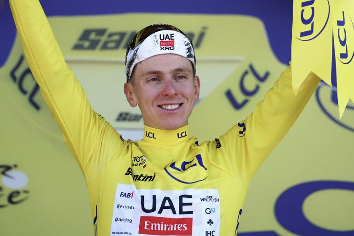UAE Team Emirates - XRG team's Slovenian rider Tadej Pogacar celebrates on the podium with the overall leader's yellow jersey after the 13th stage of the 112th edition of the Tour de France cycling race, 10.9 km individual time trial between Loudenvielle and Peyragudes, in the Pyrenees mountains of southwestern France, on July 18, 2025. Anne-Christine POUJOULAT / AFP