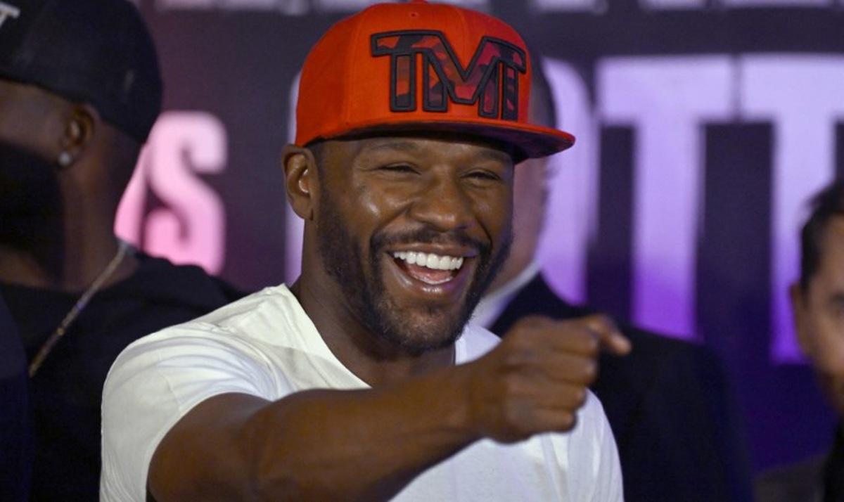 US boxer Floyd Mayweather Jr. gestures during the weighing ceremony for his upcoming exhibition fight against John Gutti III in Mexico City on August 23, 2024. Mayweather Jr. and Gotti III will face each other in an exhibition fight in Mexico on August 24, 2024. ALFREDO ESTRELLA / AFP