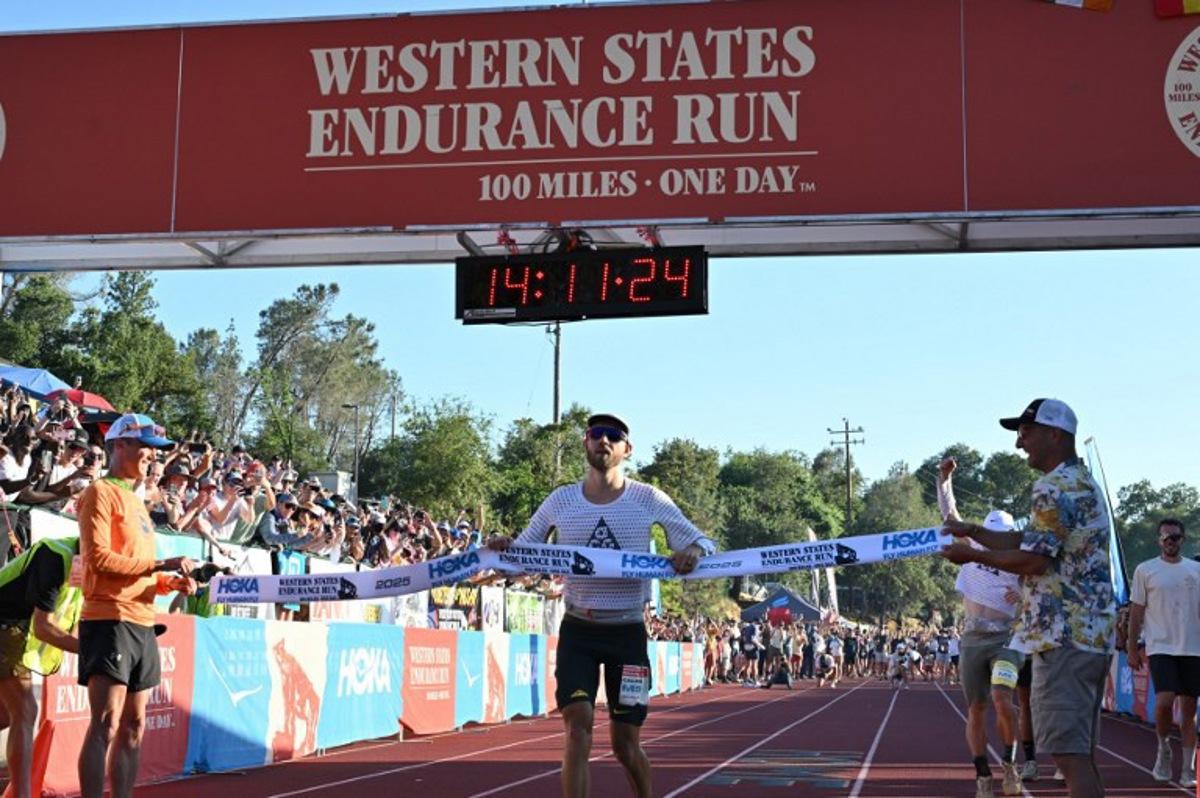 USA's Caleb Olson crosses the finish line to win the 2025 Western States Endurance Run with a time of 14 hours 11 minutes and 25 seconds, at Placer High School in Auburn, California on June 28, 2025. The Western States Endurance Run, the world's oldest 100-mile trail race, takes 369 runners from the Olympic Valley valley floor (elevation 6,200 feet) to Emigrant Pass (elevation 8,750 feet), a climb of 2,550 vertical feet in the first 4½ miles. From the pass, following the original trails used by the gold and silver miners of the 1850's, runners travel west, climbing another 15,540 feet and descending 22,970 feet before reaching Auburn, a small town in the heart of California's historic gold country. Most of the trail passes through remote and rugged territory. Robyn Beck / AFP