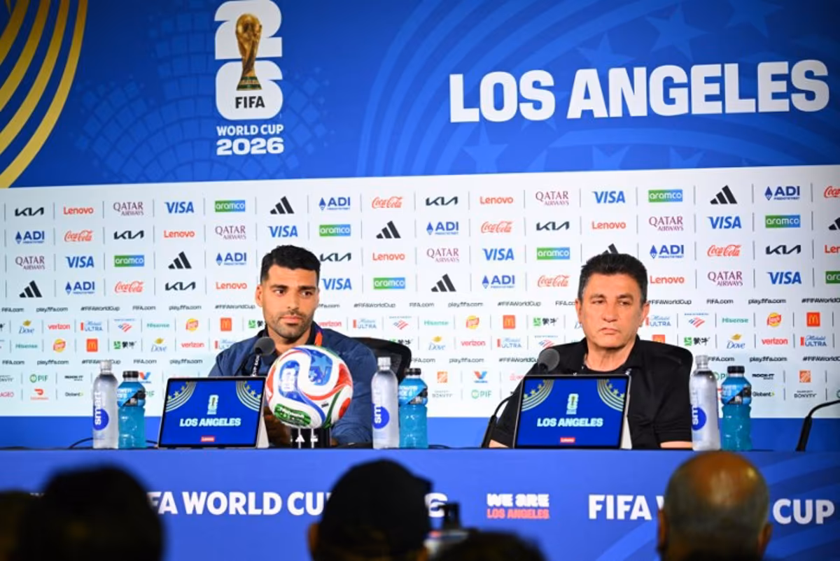 Iran's head coach Amir Ghalenoei (R) gives a press conference next to Iran's forward #09 Mehdi Taremi at Los Angeles Stadium in Inglewood on June 14, 2026, on the eve of the 2026 World Cup football match between Iran and New Zealand. Patrick T. FALLON / AFP