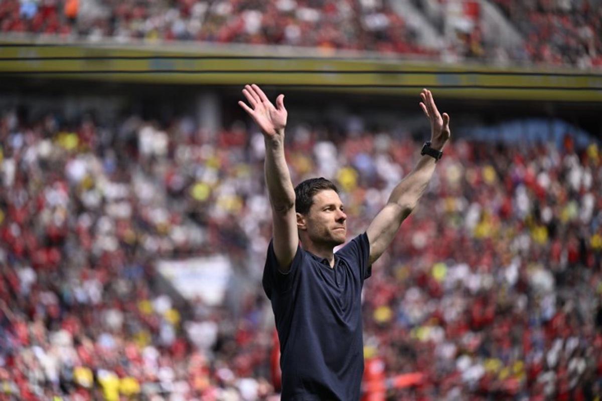 Bayer Leverkusen's outgoing Spanish head coach Xabi Alonso reacts during his farewell prior to the start of the German first division Bundesliga football match between Bayer 04 Leverkusen and Borussia Dortmund in Leverkusen, western Germany, on May 11, 2025. INA FASSBENDER / AFP