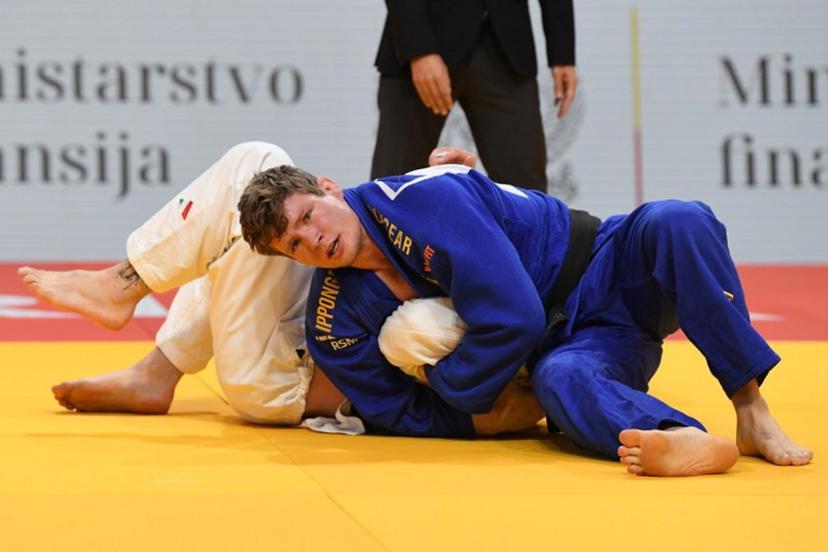 Belgium's Matthias Casse (blue) and Italy's Antonio Esposito (white) compete in the men's -81kg category during the European Championships judo in Podgorica, Montenegro, on April 25, 2025. The tournament is taking place from April 23 to 27, 2025. SAVO PRELEVIC / AFP