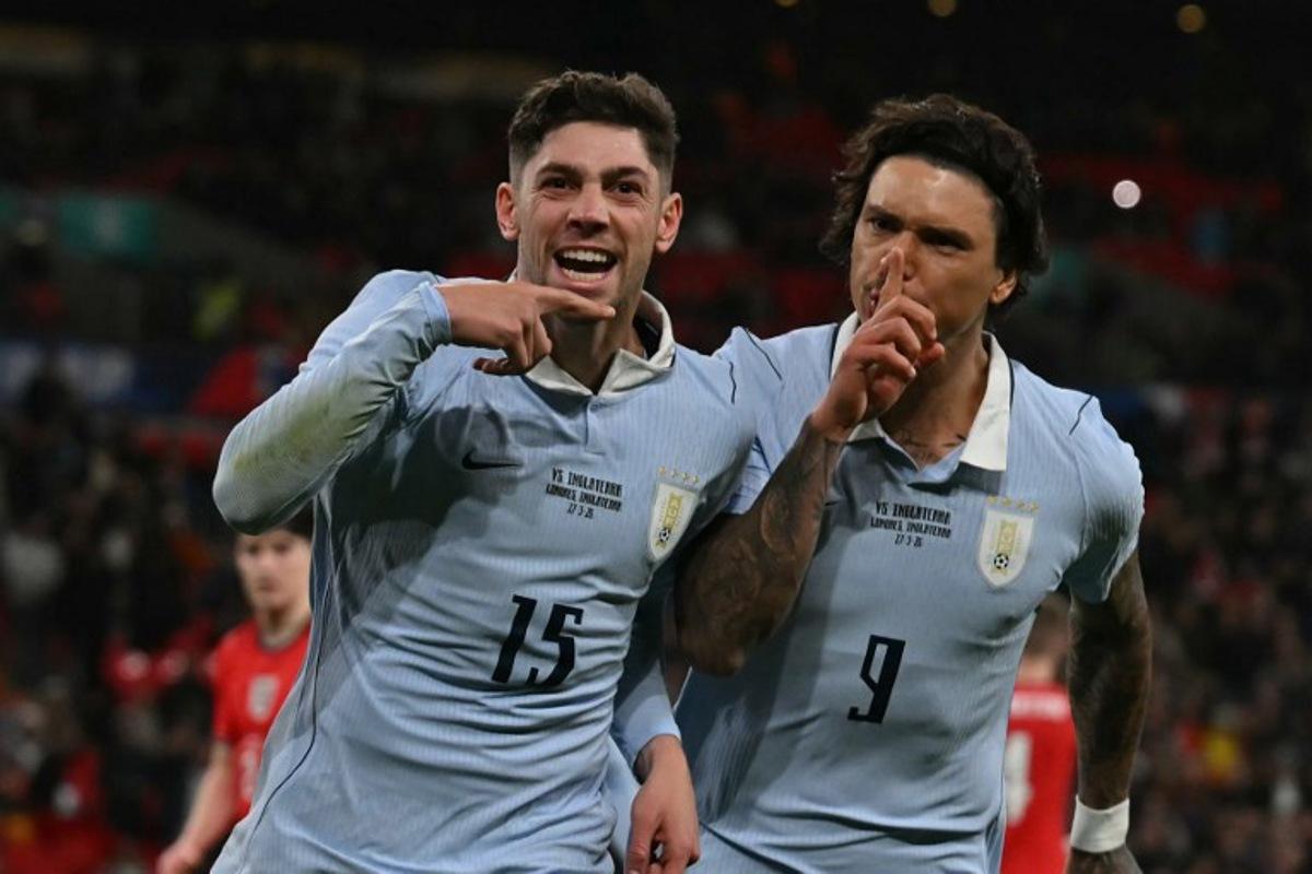 Uruguay's midfielder Federico Valverde (L) celebrates with Uruguay's forward Darwin Nunez (R) after scoring their first goal from the penalty spot during the friendly International football match between England and Uruguay at Wembley Stadium, west London, on March 27, 2026. Glyn KIRK / AFP