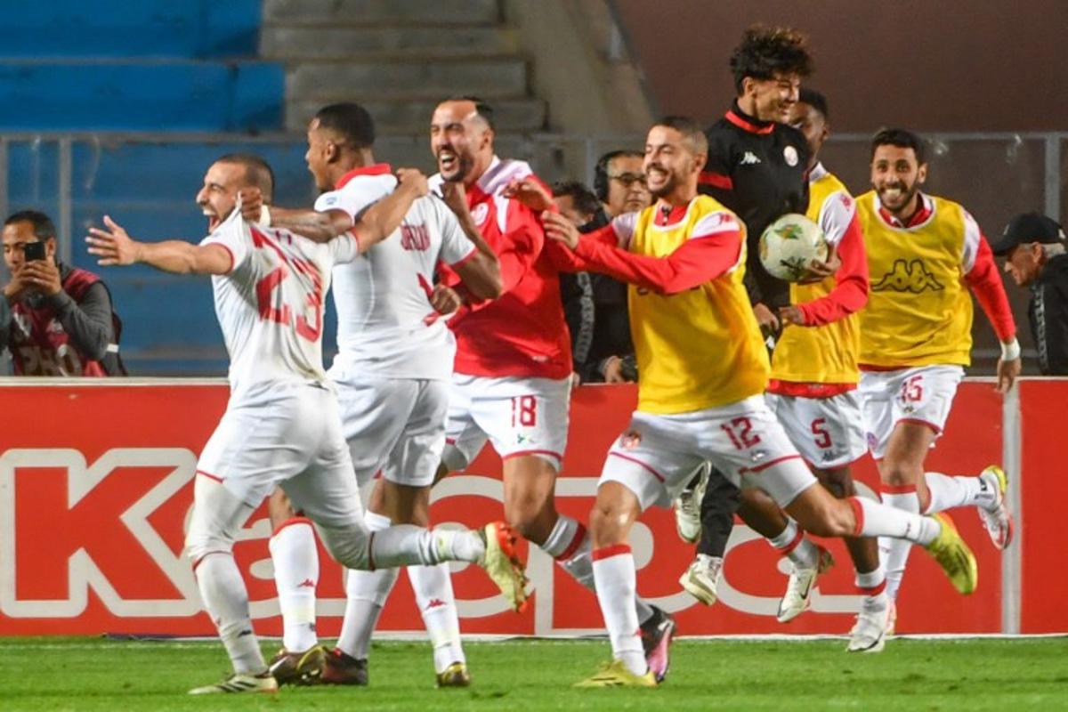 Tunisia's forward #11 Seifeddine Jaziri celebrates with his teammates after scoring his team's first goal during the FIFA World Cup 2026 Africa zone qualifiers group H football match between Tunisia and Malawi at Hammadi Agrebi Stadium in Tunis on March 24, 2025. FETHI BELAID / AFP